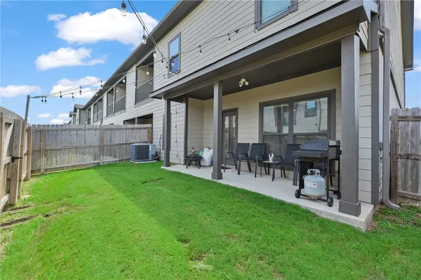 a view of a house with a backyard and a patio