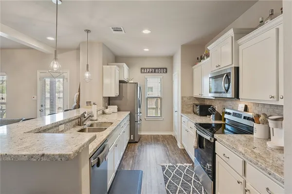 a kitchen with a sink stove and refrigerator