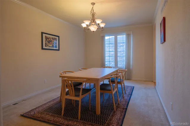 a view of a dining room with furniture and window