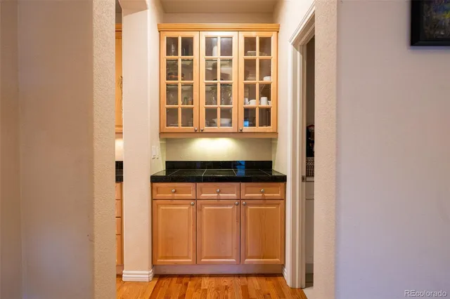 a kitchen with granite countertop white cabinets and white appliances