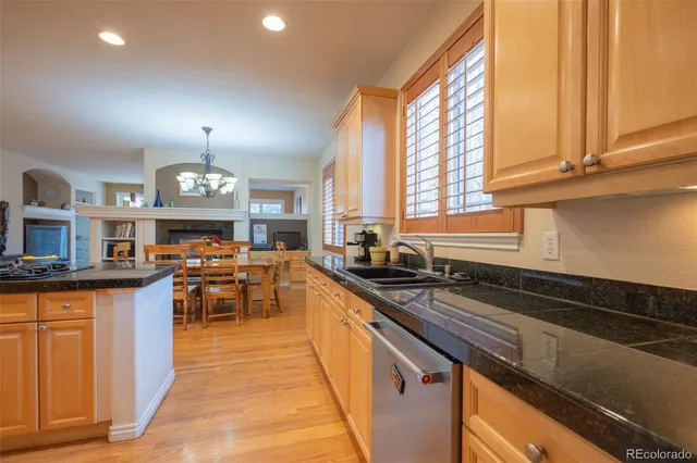a kitchen with stainless steel appliances granite countertop a sink a stove counter space and cabinets