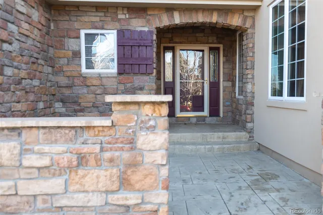 a view of entrance of the house with large windows