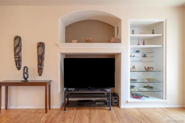 a living room with a fireplace and a flat screen tv