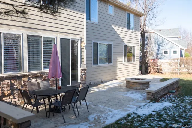 a view of a patio with table and chairs and wooden floor