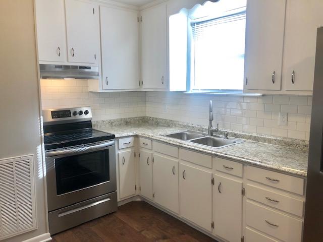 7820 Chester Road Fairview, TN 37062 - Photo 14 of 22 a kitchen with granite countertop white cabinets and white appliances