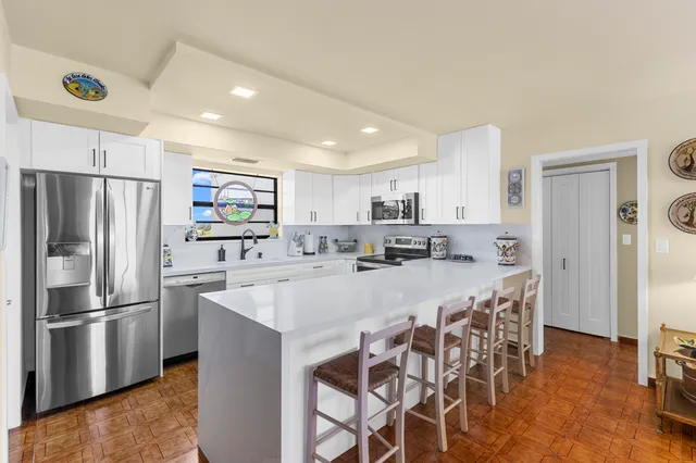 a kitchen with stainless steel appliances granite countertop a sink and a stove