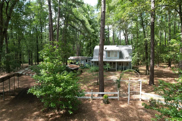 a view of a chair and tables in the patio next to a yard