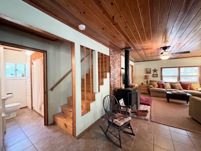 a view of a livingroom with furniture and floor to ceiling window