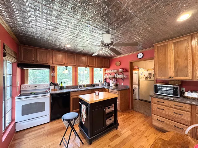 a kitchen with a stove a sink and a refrigerator