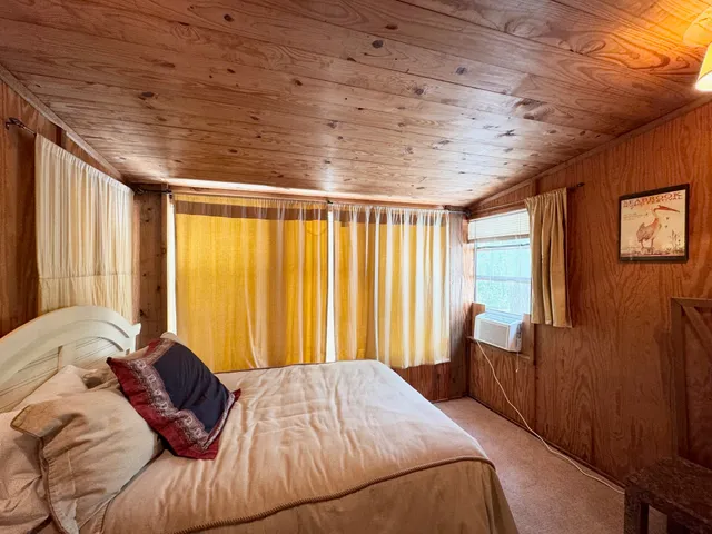 a bed sitting in a bedroom next to a window