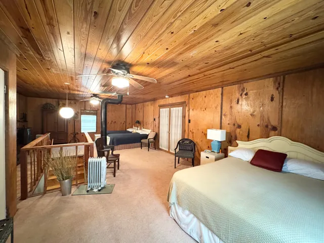 a bedroom with furniture and a large window