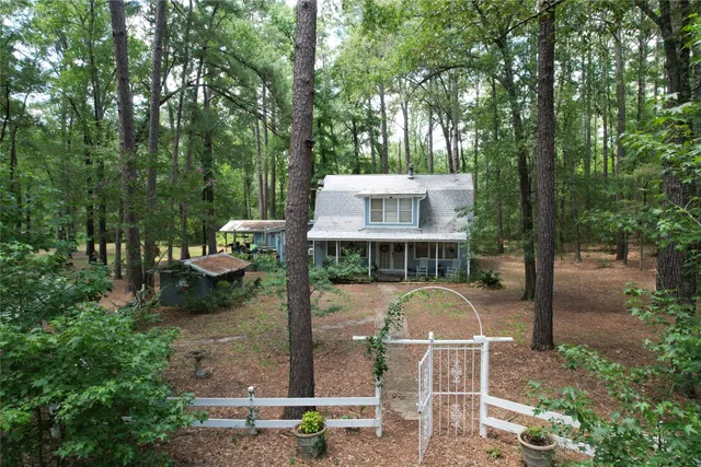 a view of a chair and table in the backyard