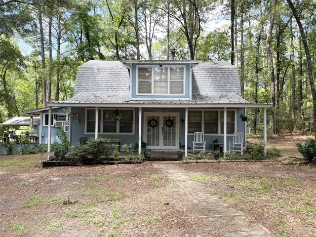 a front view of a house with garden and porch