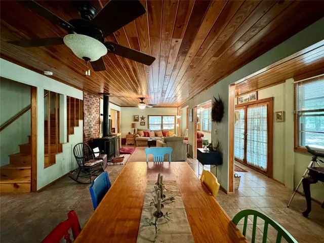 a view of a livingroom with furniture hardwood floor and a large window