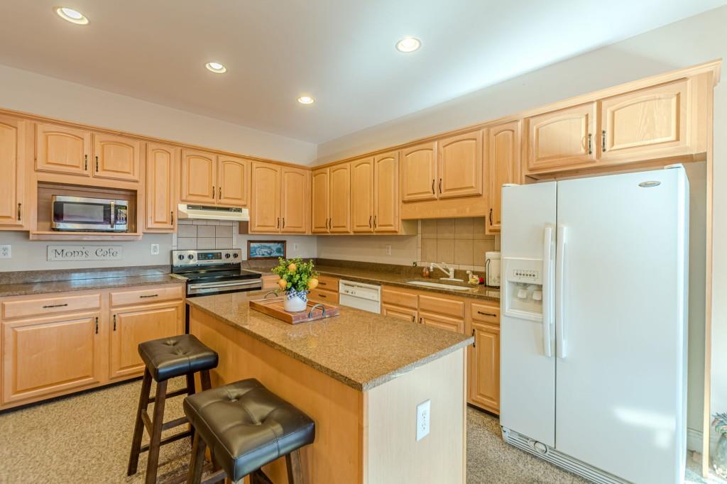4346 Leola Road Douglasville, GA 30135 - Photo 18 of 59 a kitchen with a refrigerator a stove a sink dishwasher and white cabinets with wooden floor