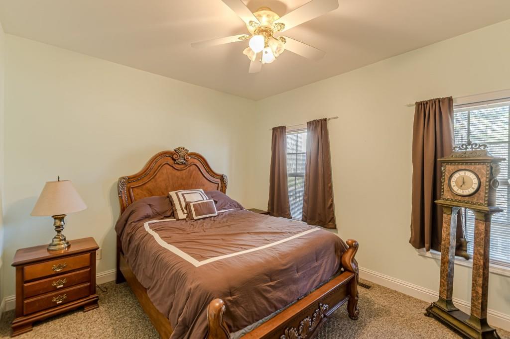 4346 Leola Road Douglasville, GA 30135 - Photo 25 of 59 a bedroom with a bed and a chandelier