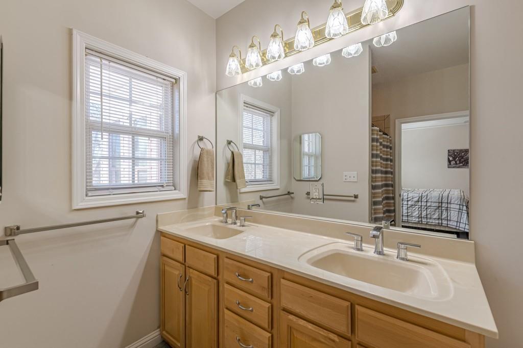 4346 Leola Road Douglasville, GA 30135 - Photo 37 of 59 a bathroom with a sink double vanity and a mirror