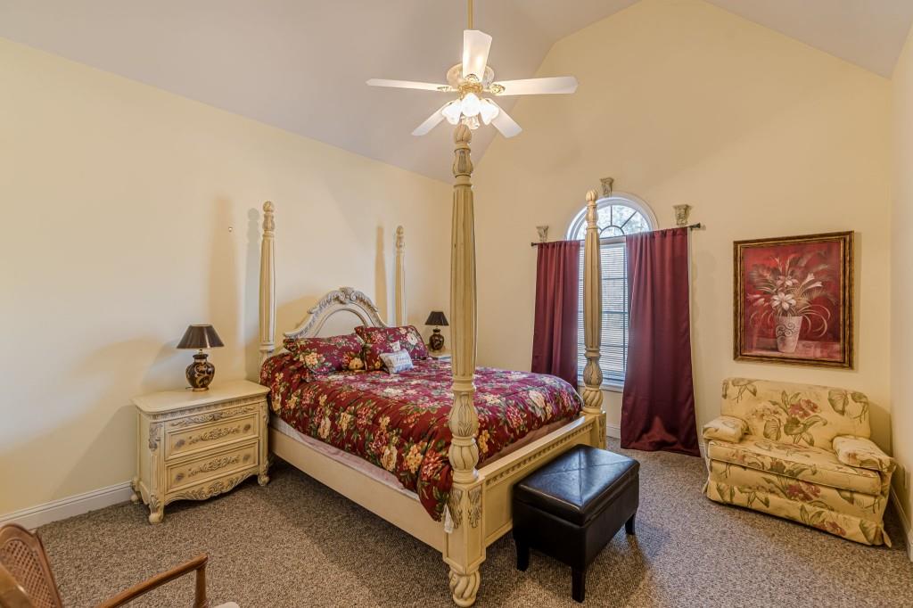 4346 Leola Road Douglasville, GA 30135 - Photo 39 of 59 a bed room with a bed and a chandelier