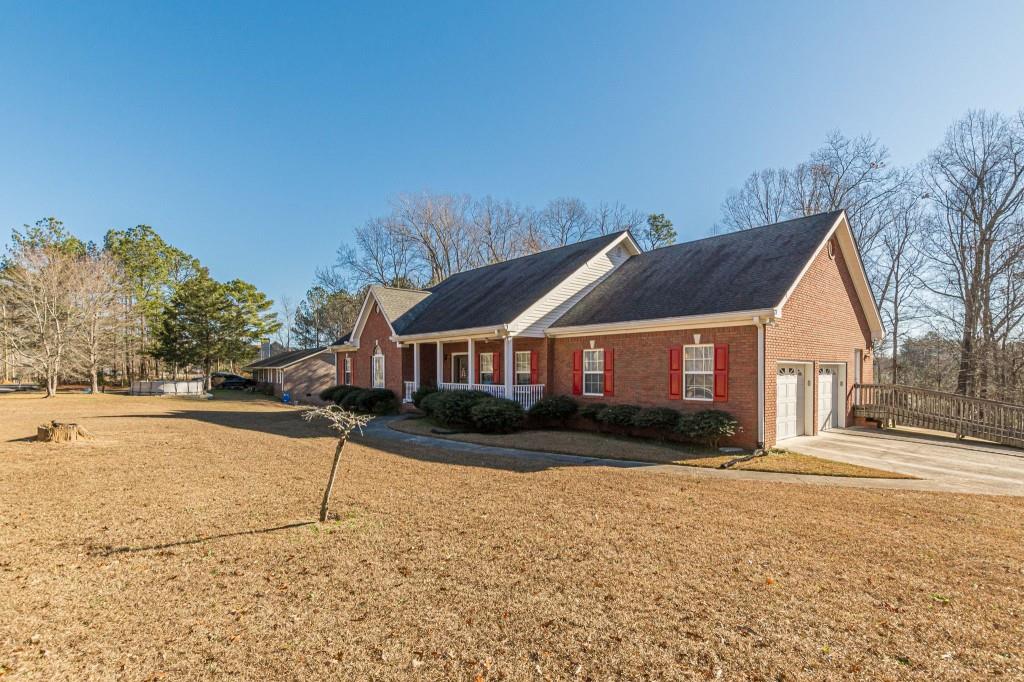 4346 Leola Road Douglasville, GA 30135 - Photo 4 of 59 a front view of a house with a yard and garage