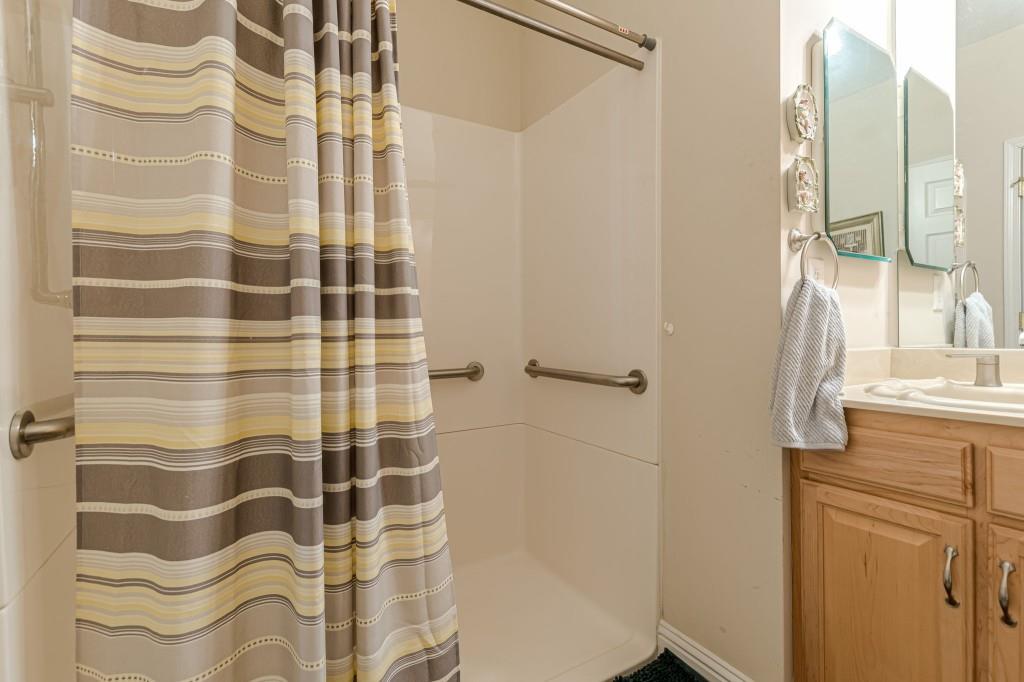4346 Leola Road Douglasville, GA 30135 - Photo 43 of 59 a bathroom with a shower curtain and a sink