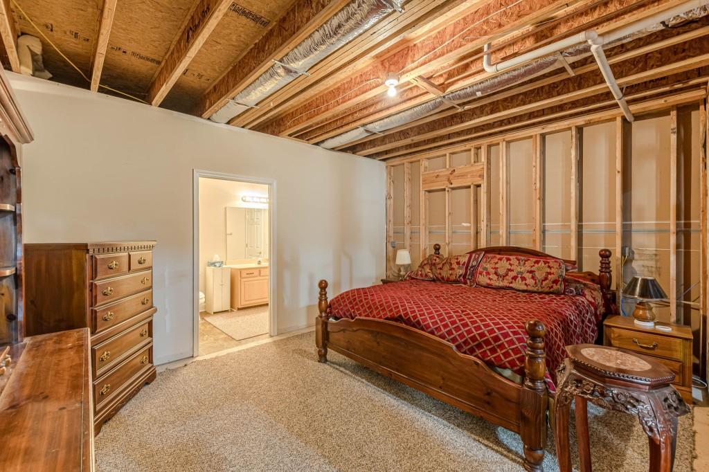 4346 Leola Road Douglasville, GA 30135 - Photo 49 of 59 a bed sitting in a spacious bedroom next to a window