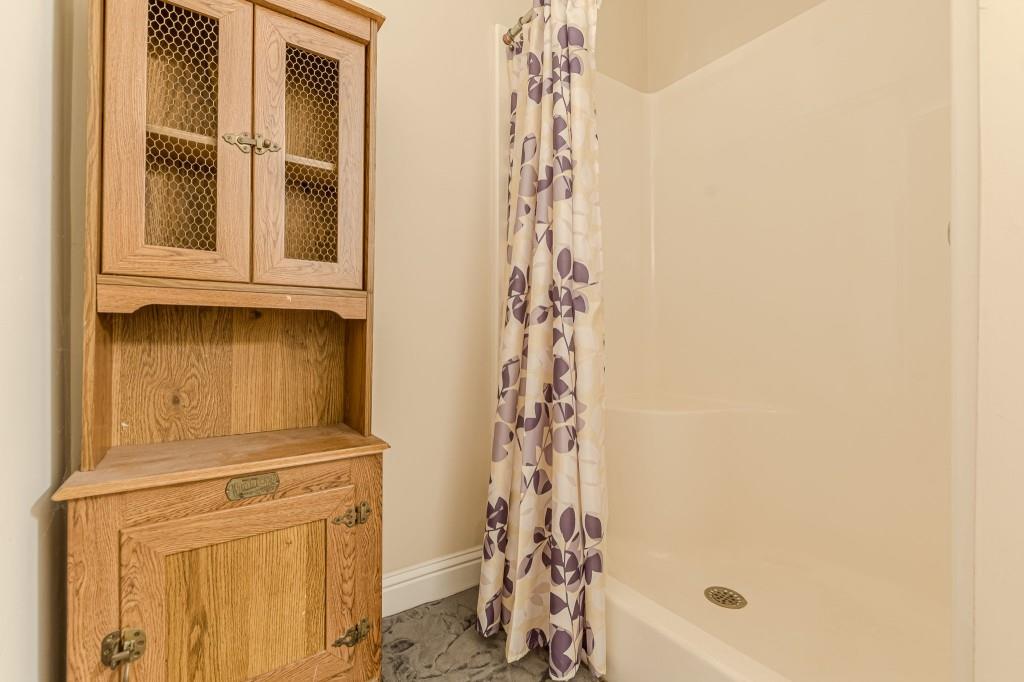 4346 Leola Road Douglasville, GA 30135 - Photo 52 of 59 a bathroom with a granite countertop shower and a sink