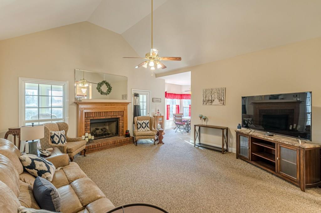 4346 Leola Road Douglasville, GA 30135 - Photo 10 of 59 a living room with furniture a fireplace and a flat screen tv