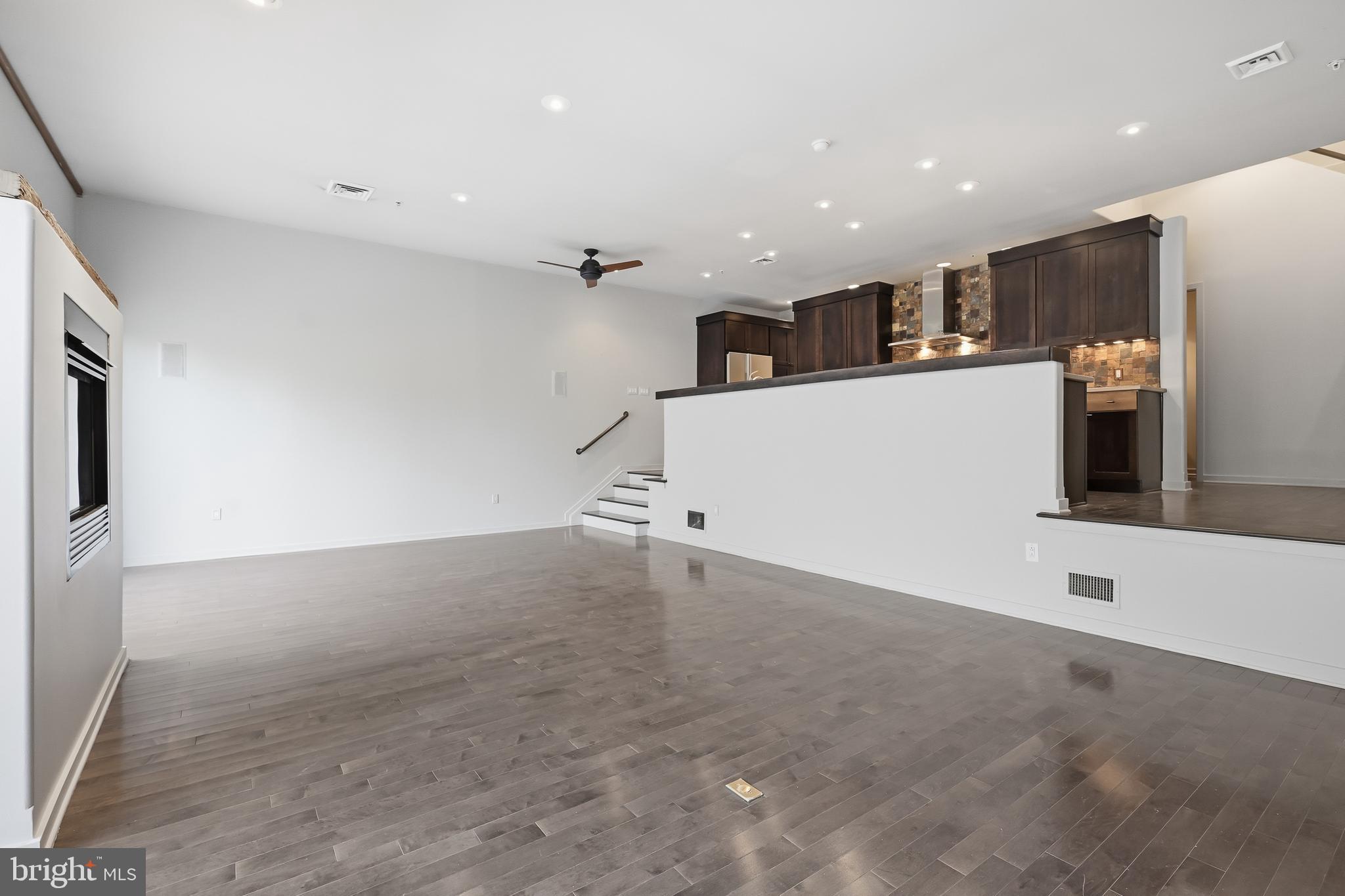 118 Bancroft Mills Road Wilmington, DE 19806 - Photo 11 of 36 a view of a kitchen with a refrigerator and a counter top