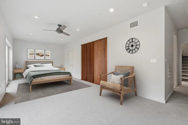a bedroom with a bed and a chair