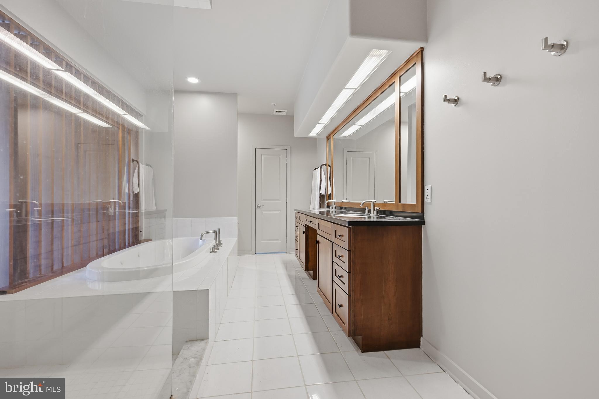 118 Bancroft Mills Road Wilmington, DE 19806 - Photo 21 of 36 a bathroom with a granite countertop sink a mirror and shower