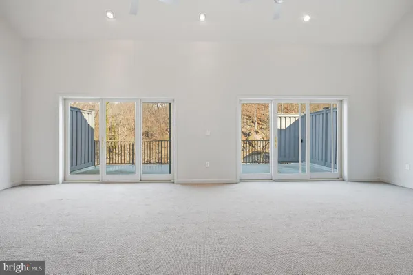 an empty room with large window and doors