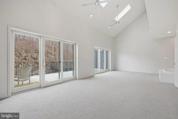 a view of an empty room with glass door
