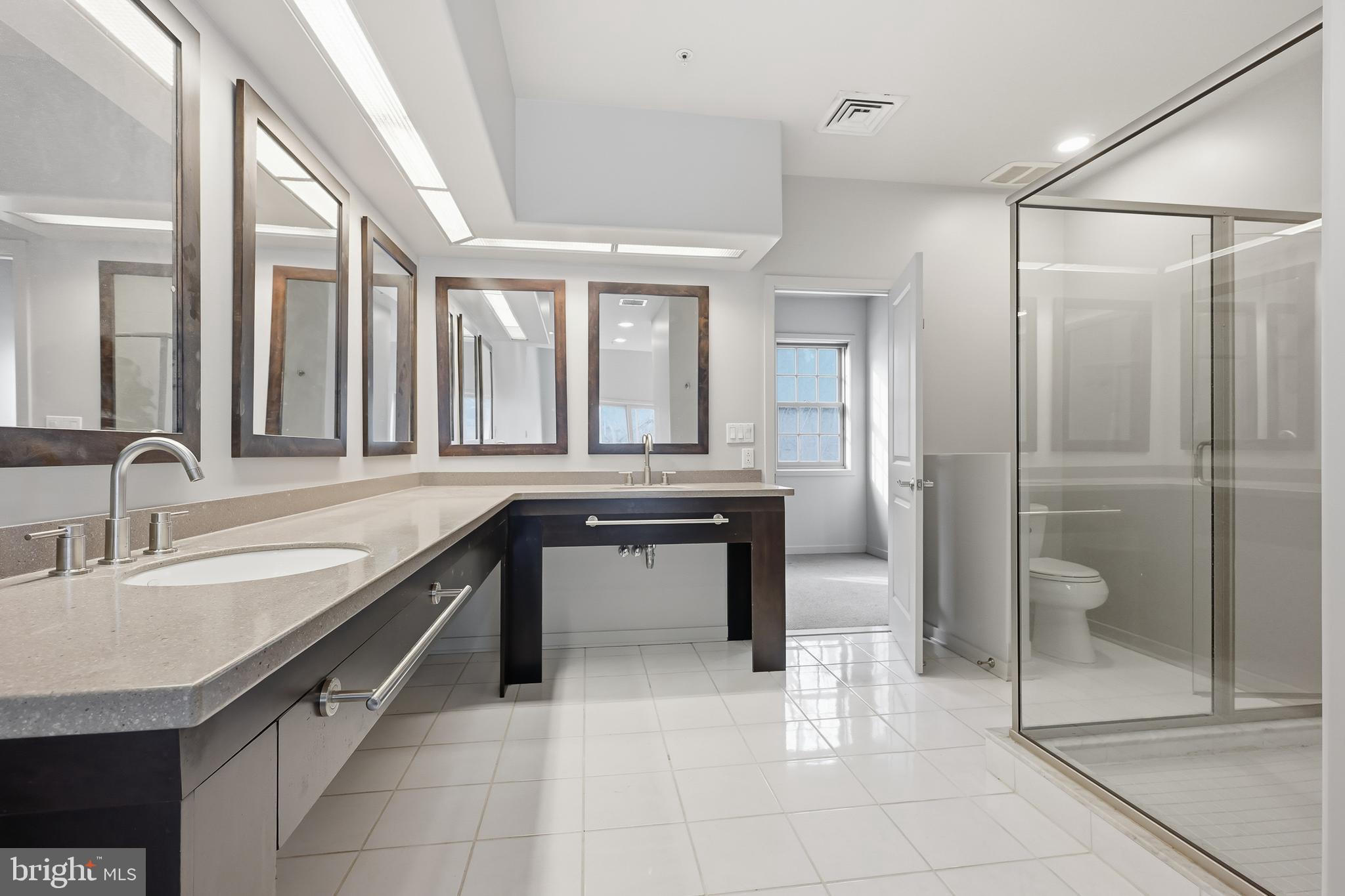 118 Bancroft Mills Road Wilmington, DE 19806 - Photo 29 of 36 a large bathroom with a granite countertop sink mirror and a bathtub
