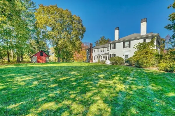 an aerial view of a house with a yard and lake view