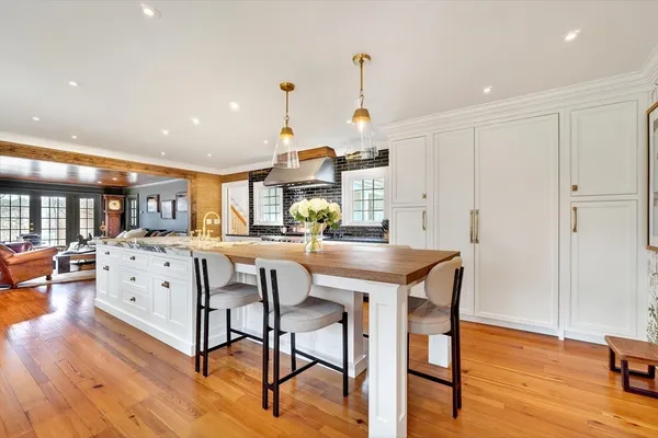 a view of a kitchen with furniture and wooden floor