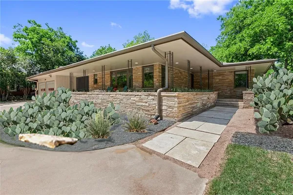 a front view of a house with garden