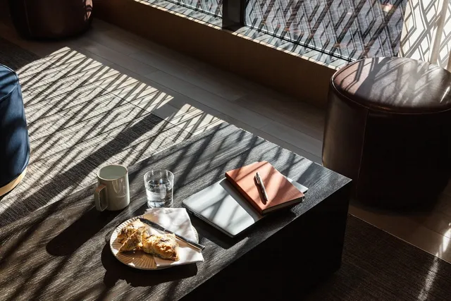 a living room with furniture and a floor to ceiling window
