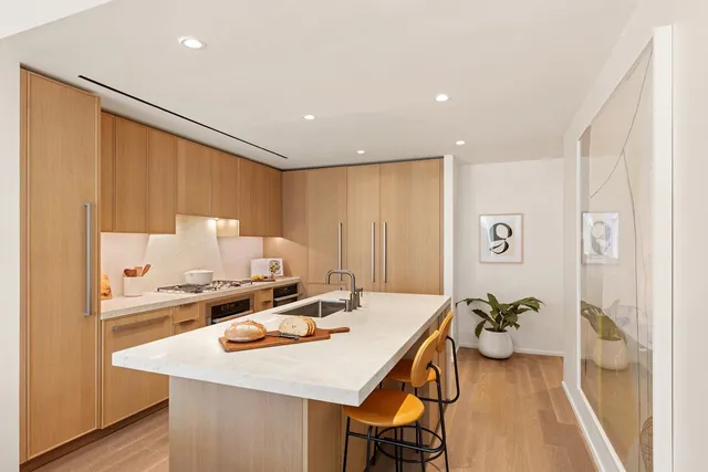 a view of a kitchen area with furniture and wooden floor