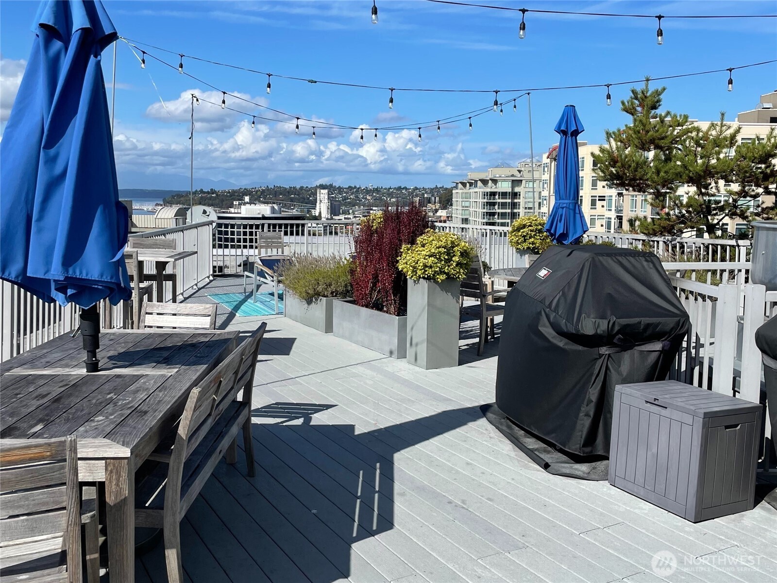 76 Cedar Street, Unit 405 Seattle, WA 98121 - Photo 22 of 32 a dinning table and chairs in a patio