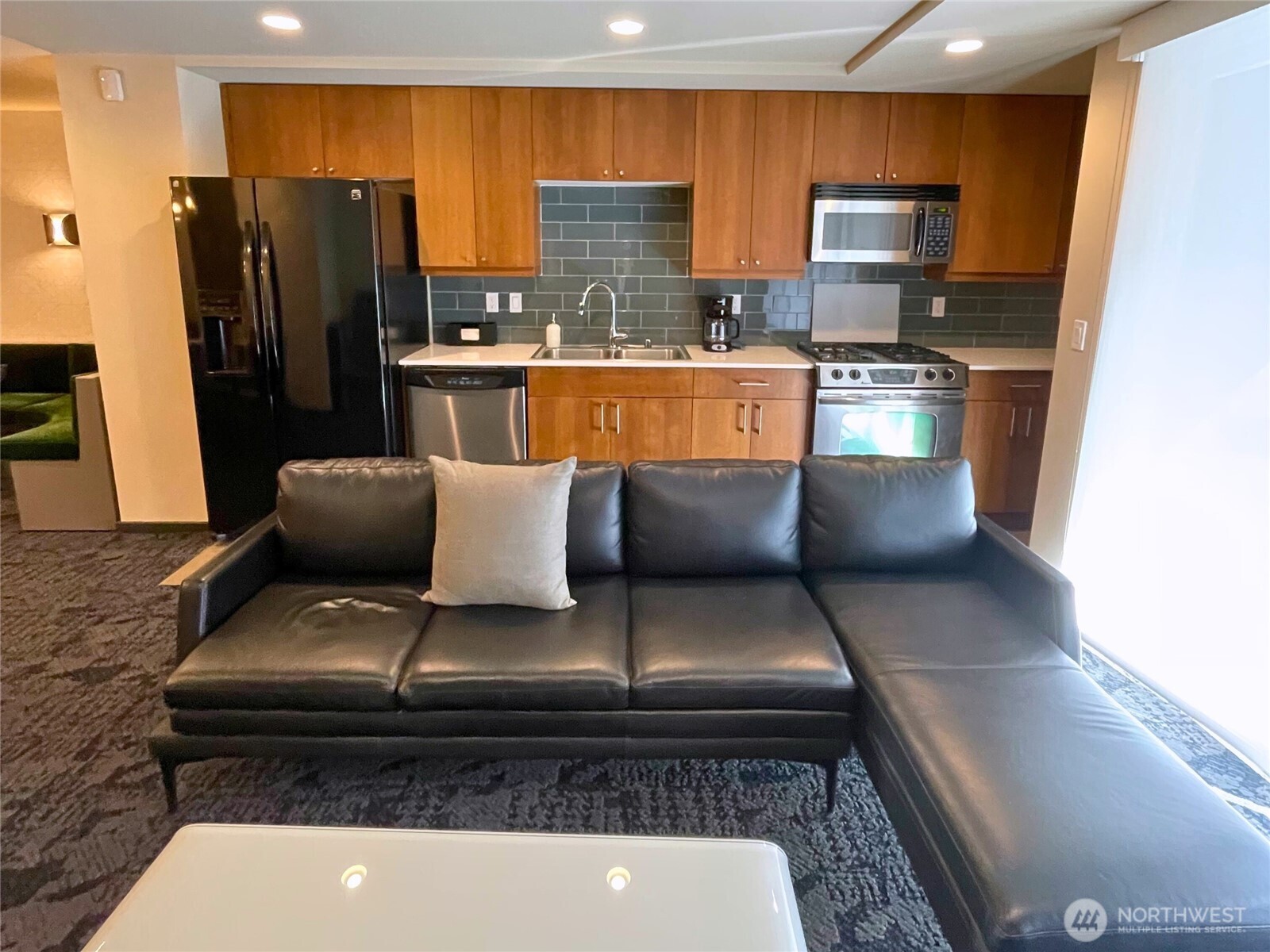 76 Cedar Street, Unit 405 Seattle, WA 98121 - Photo 27 of 32 a kitchen with stainless steel appliances granite countertop a refrigerator and a stove top oven