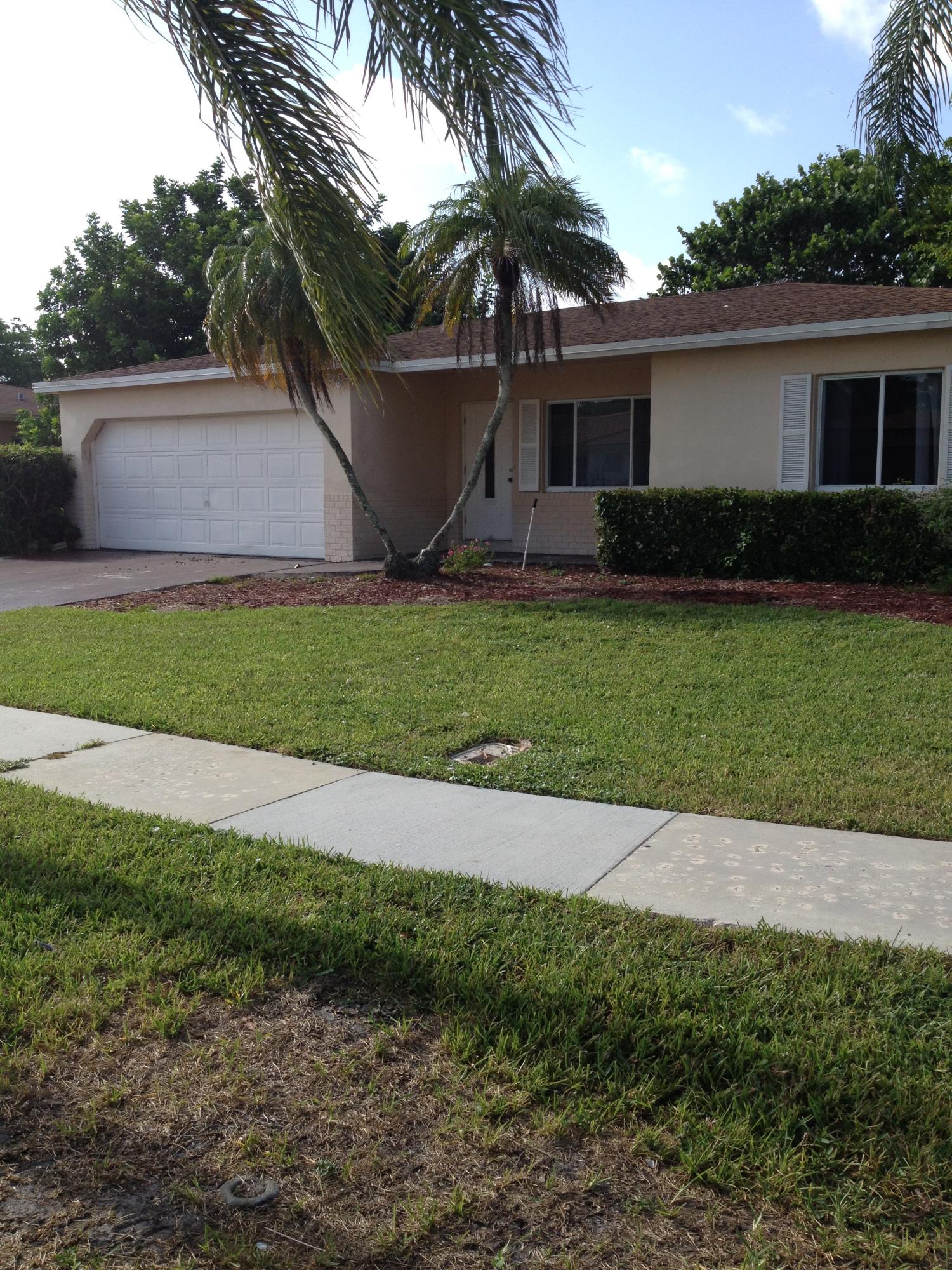 11198 Mandarin Street Boca Raton, FL 33428 - Photo 1 of 22 a front view of house with yard and trees