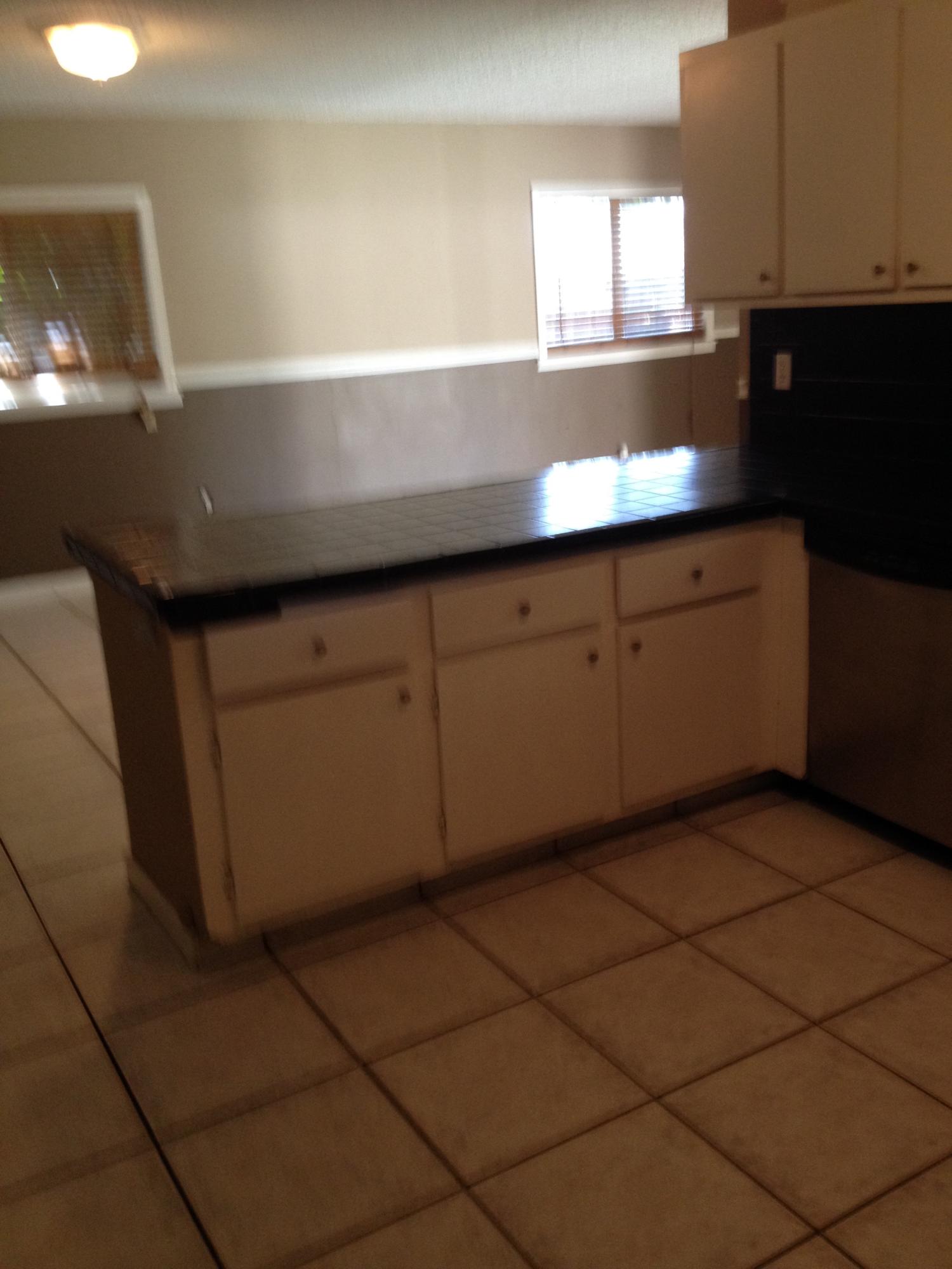 11198 Mandarin Street Boca Raton, FL 33428 - Photo 4 of 22 a kitchen with stainless steel appliances a sink stove and cabinets