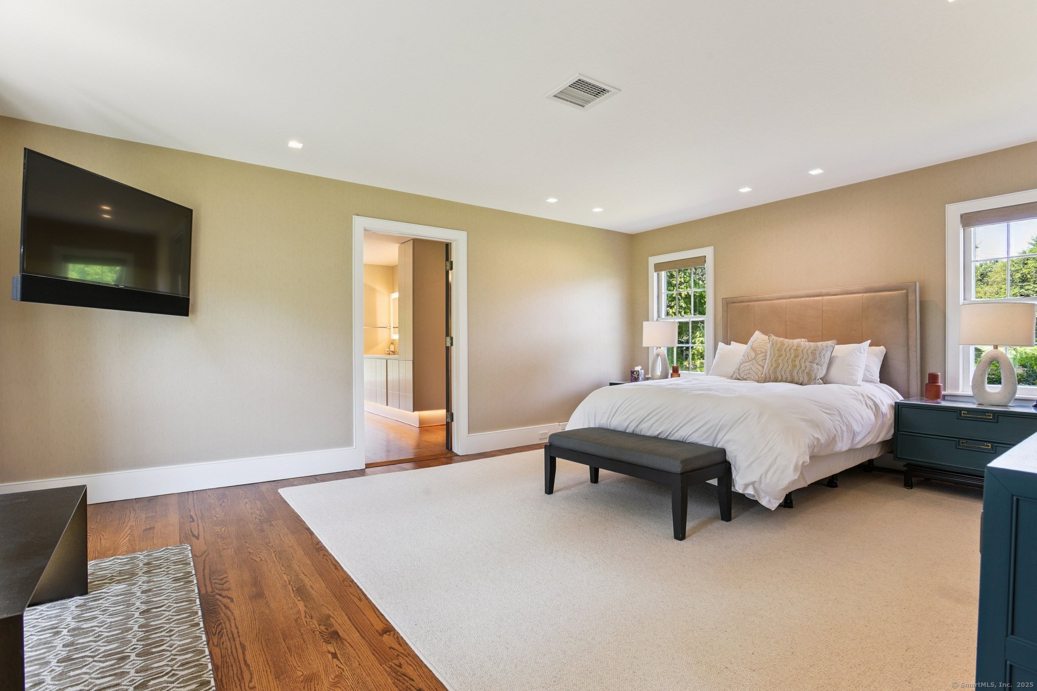 455 Stonington Road Stonington, CT 06378 - Photo 17 of 39 a bedroom with a bed and a flat screen tv