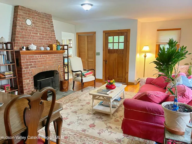 a living room with furniture fireplace and window