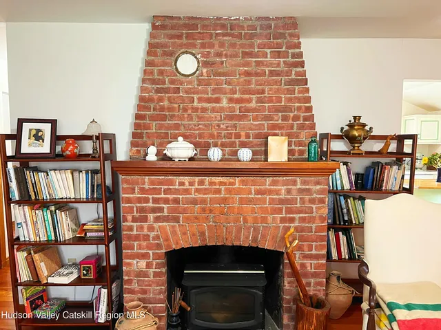 a view of a fireplace and window in a room