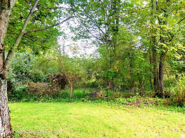 a backyard of a house with a yard and outdoor seating