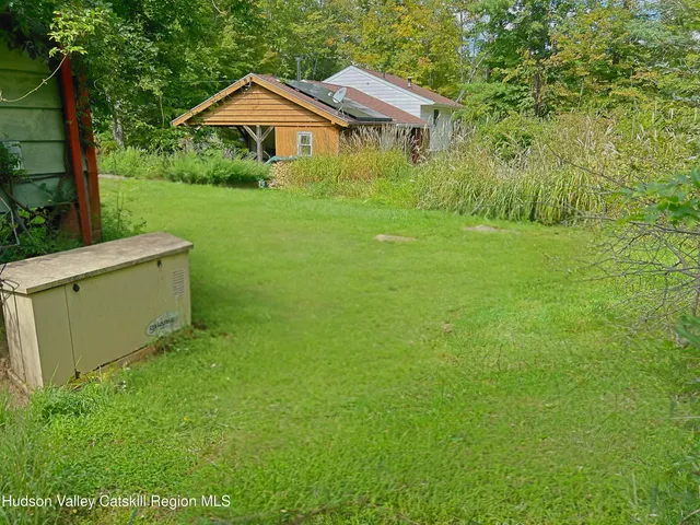 a front view of a house with yard and green space