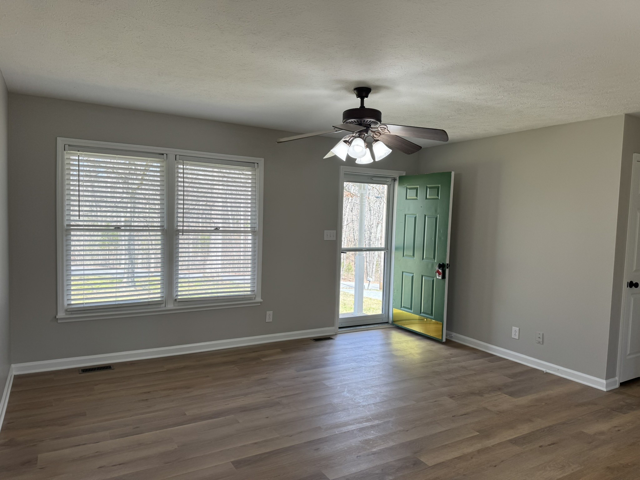 226 Nottingham Road Dickson, TN 37055 - Photo 4 of 17 a view of an empty room with a window and wooden floor