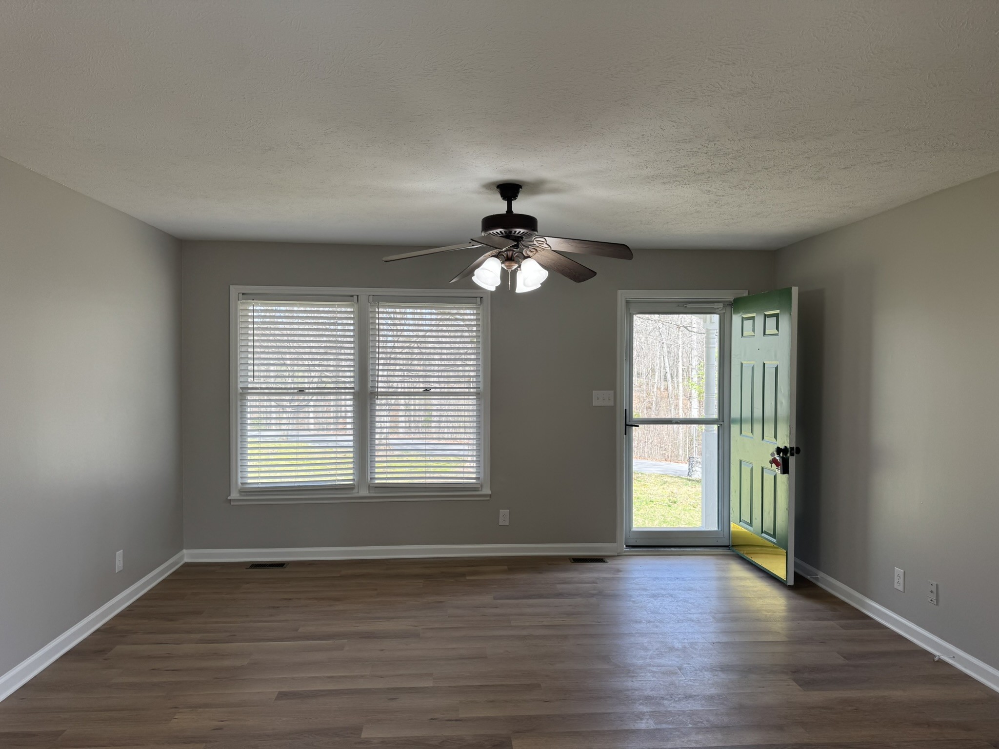 226 Nottingham Road Dickson, TN 37055 - Photo 5 of 17 a view of an empty room with wooden floor and a window