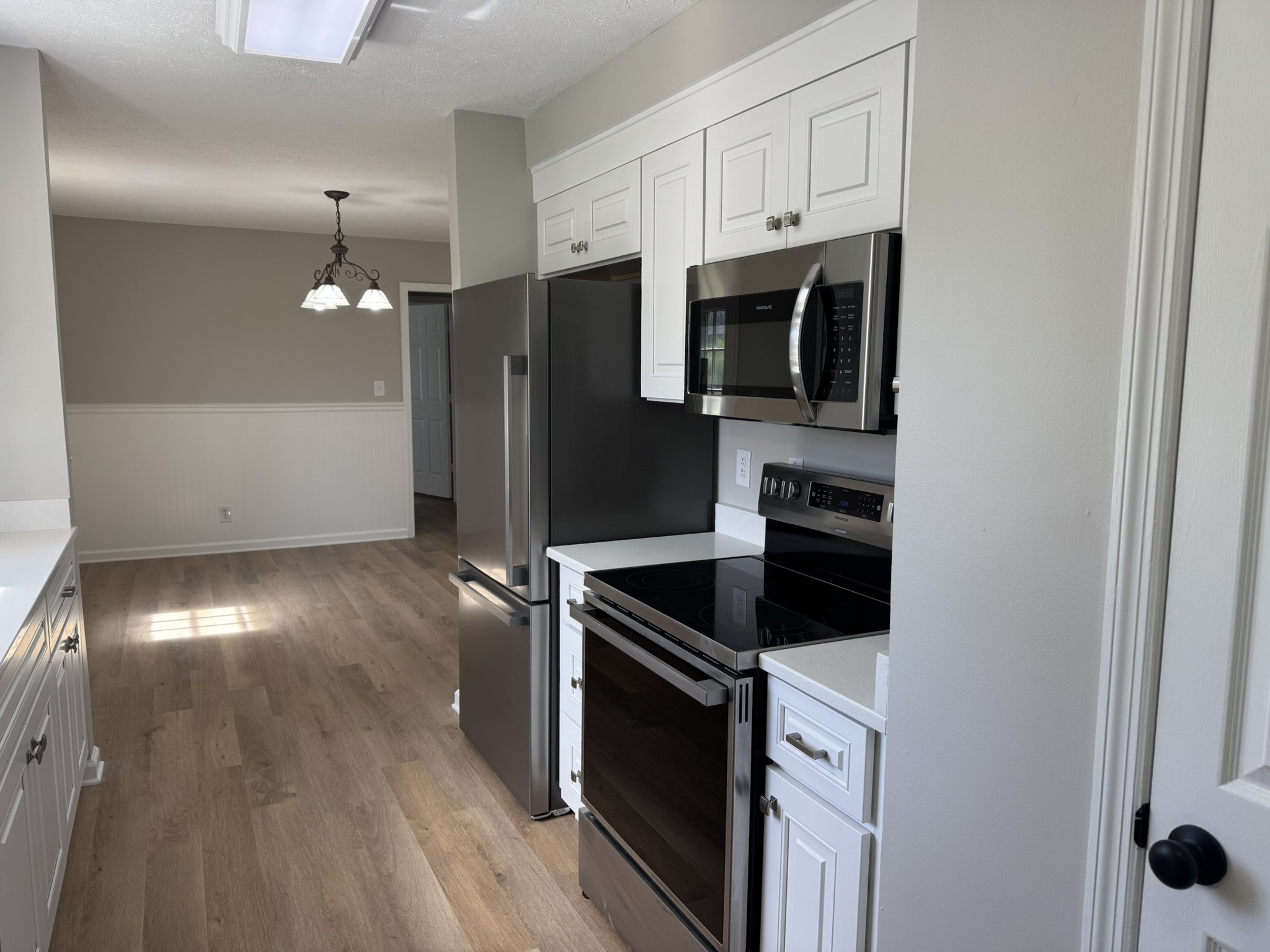 226 Nottingham Road Dickson, TN 37055 - Photo 8 of 17 a kitchen with stainless steel appliances granite countertop a stove a microwave and a refrigerator